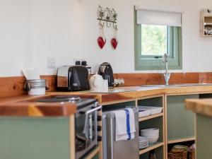 a kitchen with a sink and a counter top at Olive in Wootton Bridge