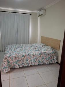 a bedroom with a bed with a comforter on it at Ocean View Tabatinga Residence in Barra de Tabatinga +13 photos