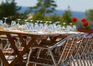 a long wooden table with chairs and wine glasses at Tofta Strandpensionat in Tofta