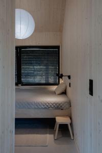 a small room with a bed and a window at Wood Rest, MyWeek in Stronie Śląskie