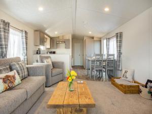 a living room with a couch and a table at Burray in Mey +21 photos