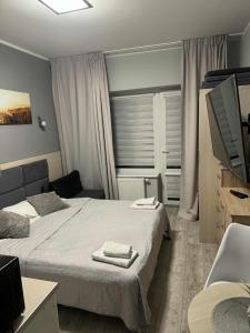 a hotel room with two beds and a television at Apartament Hanka 13 w Dominikana Family Resort Spa in Sianozety +31 photos