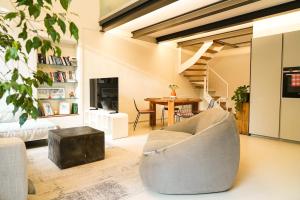 a living room with a couch and a table at Loft In Centro in Forlì