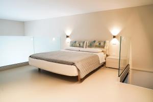 a bedroom with a large bed and a mirror at Loft In Centro in Forlì