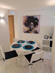 a dining room with a white table and chairs at Renovierte Wohnung in 8903 Birmensdorf in Birmensdorf
