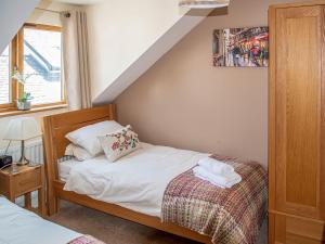 a small bedroom with a bed and a window at The Old Laundry 3 in Keswick