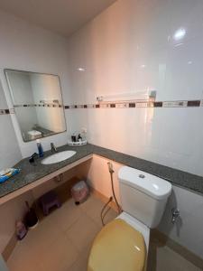 パタヤ・セントラルにあるCenter Point Condoのトイレ、洗面台、鏡のあるバスルーム