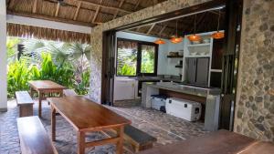a kitchen with a wooden table and a sink at Senda Beach House Tayrona in Buritaca