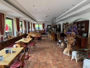 a restaurant with wooden tables and chairs in a room at Schönmoosalm - Four-Bedroom Standard Apartment in Krimml