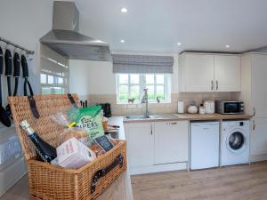 a kitchen with a basket of food and a sink at The Shambles in Fulletby +12 photos