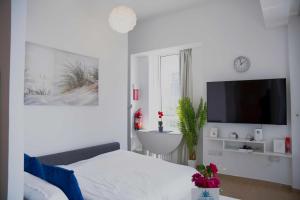 Μια τηλεόραση ή/και κέντρο ψυχαγωγίας στο Luxury Jr. 1BR in Mayan Yas Island +32 φωτογραφίες