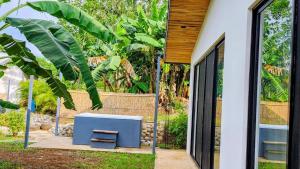 a room with a blue bench in front of a house at Private rainforest villa up to 8 guests w jacuzzi near Rio Celeste in Upala +14 photos