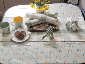a table with a plate of food on a bed at Elms Cottage - Sadberge in Long Newton +16 photos