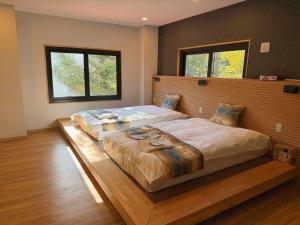 a bedroom with a large bed with a wooden headboard at 苗場サンバレーホテル in Minami Uonuma