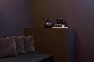 a table with a couch and two vases on it at Athens Icon Collection in Athens