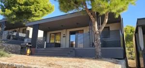 a house with a tree in front of it at Maui, Kamp Heron, Drage, Croatia in Drage