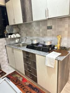 a kitchen with a stove and a sink at Calm getaway in Rongai in Ongata Rongai 