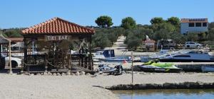 a life bar on the shore of a marina with boats at Maui, Kamp Heron, Drage, Croatia in Drage