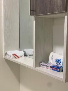 a shelf with towels and toiletries in a bathroom at Calm getaway in Rongai in Ongata Rongai 