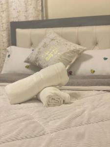 a white towel laying on top of a bed at Calm getaway in Rongai in Ongata Rongai  +19 photos
