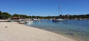 a group of boats in the water near a beach at Maui, Kamp Heron, Drage, Croatia in Drage