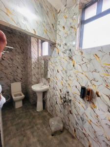 a bathroom with a sink and a toilet at The Tulsi Garden - Ashram vihar vrindavan in Vrindāvan