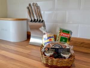 a basket filled with food sitting on a table at Gwynt Y Môr in Tywyn +13 photos