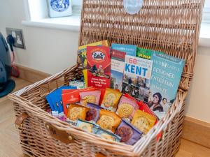 a basket filled with different types of food and books at Beach Haven - Uk42241 in Littlestone-on-Sea