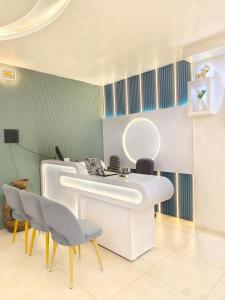 a bathroom with a sink and two chairs and a mirror at Private room & attached washroom 102 , Zero mile in Patna