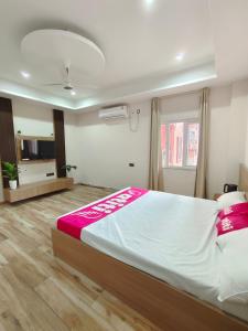 a bedroom with a large bed and a television at Private room & attached washroom 102 , Zero mile in Patna +9 photos