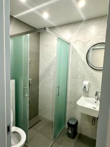 a bathroom with a shower and a toilet and a sink at Prenoćište Vozač in Jajce