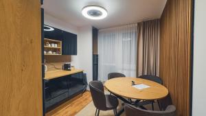 a dining room with a table and chairs at Apartmán Astana in Levoča