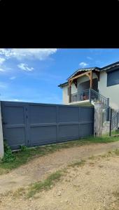 a blue fence in front of a house at Haut de maison T4 à Petit Canal in Petit-Canal