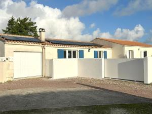 a house with two white garage doors in front of it at Maison La Luzala 2 bedrooms beach and port within walking distance in Saint-Pierre-dʼOléron