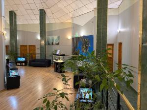a lobby with potted plants in a building at Narva Kangelaste 2 Apartments in Narva
