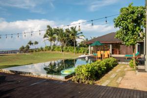 a swimming pool in the backyard of a house at Six Elements Beach Villa in Tangalle
