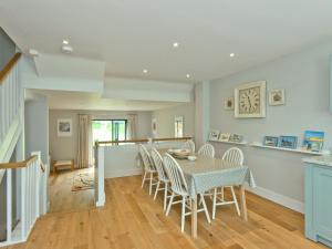a kitchen and dining room with a table and chairs at Eddystone Row 2 in Salcombe