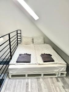 a bedroom with a bed in a attic at Káli-lak Vendégház in Köveskál