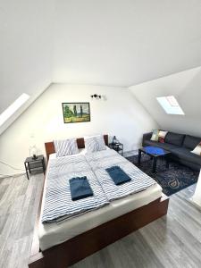 a bedroom with a large bed and a couch at Káli-lak Vendégház in Köveskál