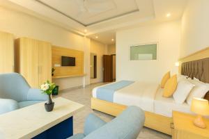 a hotel room with a bed and a chair at Doon Nature Valley Resort, Mussoorie in Mussoorie