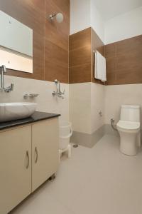 a bathroom with a sink and a toilet at Doon Nature Valley Resort, Mussoorie in Mussoorie
