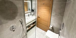 a bathroom with a sink and a toilet and a mirror at Paşapark Selçuklu Hotel in Konya +9 photos