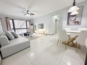 a white living room with a white couch and a table at egolife in Beijing