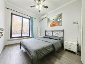 a bedroom with a bed and a ceiling fan at egolife in Beijing