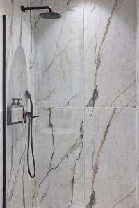 a bathroom with a shower with marble tiles at Athens Icon Collection in Athens +32 photos