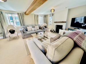 a living room with a couch and a tv at Gilbertson Cottage in Wheldrake