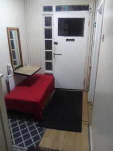 a room with a red couch and a door at Romantic Guest Rooms in London +10 photos