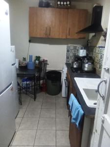 a kitchen with a sink and a stove top oven at Romantic Guest Rooms in London