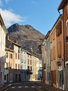 an empty street with a mountain in the background at Maison avec jardin aux Cabannes - Ariège in Les Cabannes +17 photos