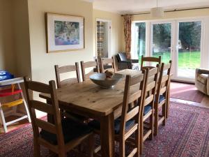 a dining room with a wooden table and chairs at Kestral in Welney